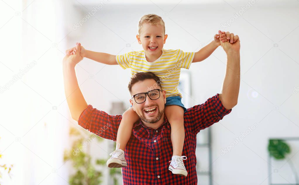 Father's day. Happy family son hugs his dad  
