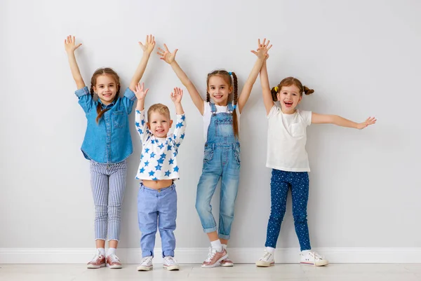 Amici bambini felici intorno al muro vuoto — Foto Stock