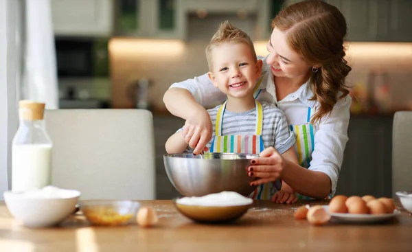 Happy family mother and son bake kneading dough in kitche — Stock Photo, Image