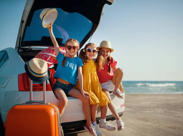 Happy children girls friends sisters on the car ride to summer t — Stock Photo, Image