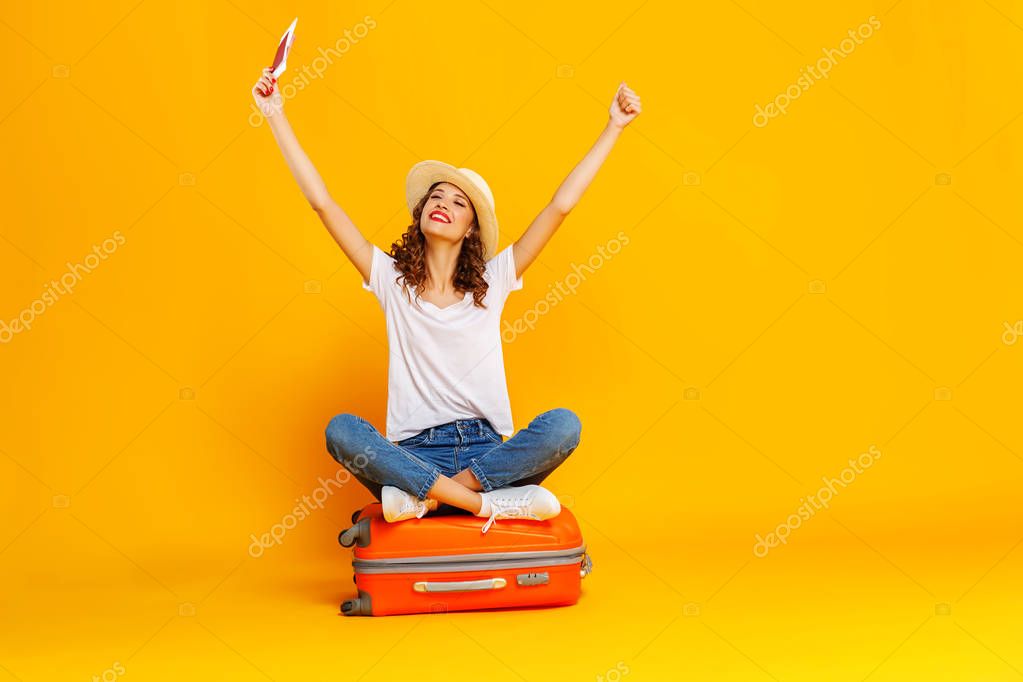 concept of travel. happy woman girl with suitcase and  passport 