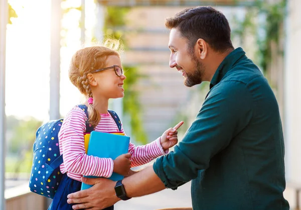 First day at school. father leads  little child school girl in f — Stock Photo, Image