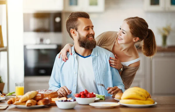 family happy couple have Breakfast in kitchen in morning