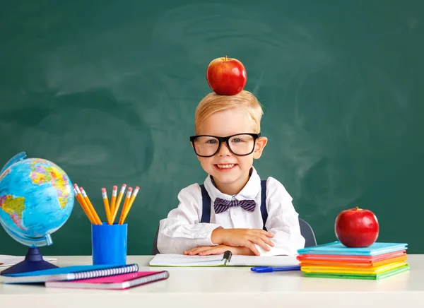 Funny child schoolboy student about school blackboard — стоковое фото