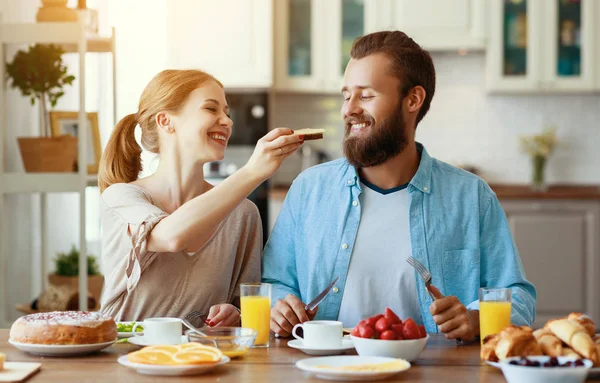 family happy couple have Breakfast in kitchen in mornin
