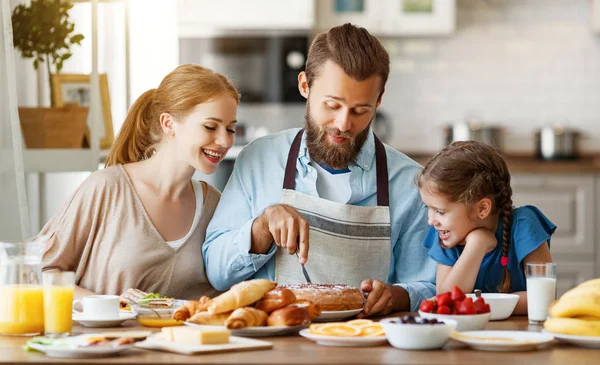 Семья мать отец и ребенок дочь имеют завтрак на кухне — стоковое фото