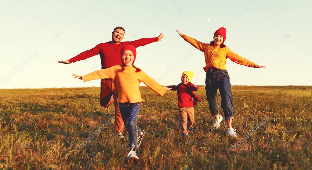 Happy family: mother, father, children son and daughter on autum