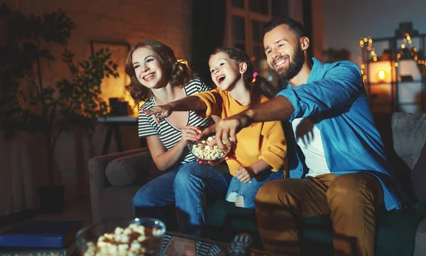 Family mother father and child daughter watching projector, TV, — Stock Photo, Image