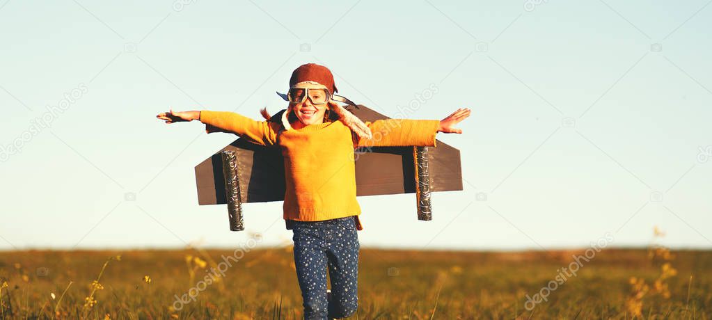 Child pilot aviator with wings of airplane dreams of traveling i