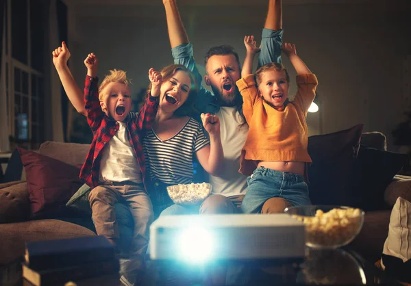 Family mother father and children watching projector, TV, movies — Stock Photo, Image