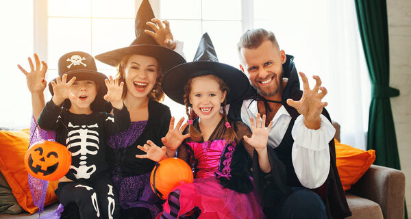 happy family mother father and children in costumes   on  Hallow