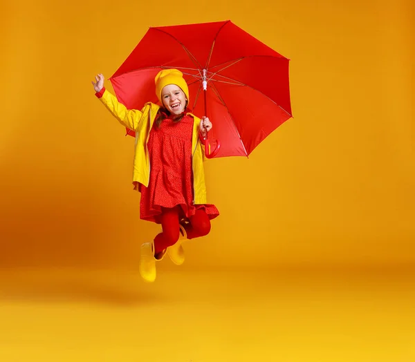 Happy emotional cheerful child girl jumping and laughing  with r — Stock Photo, Image