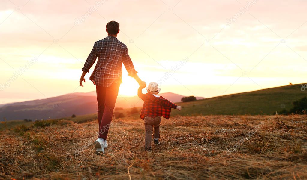 happy family father and son in nature at sunse