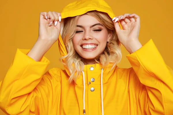 young happy emotional girl laughing  with raincoat with hood   o