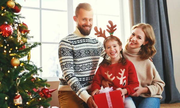 Happy family with gifts near   Christmas tree at home — ストック写真