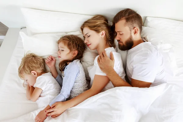 healthy sleep. happy family parents and children sleeping in whi