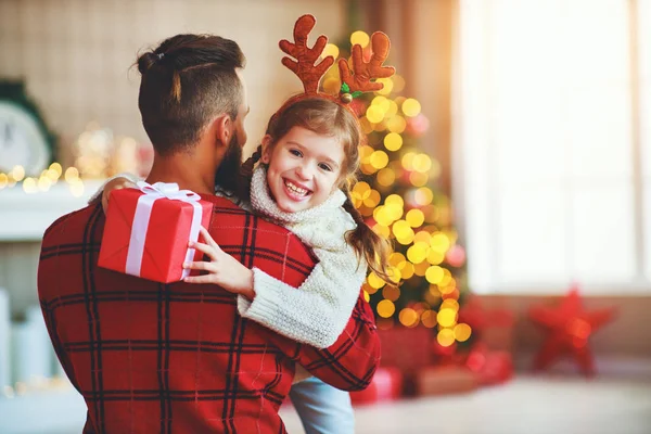 Lycklig familj far och barn dotter ger julklapp — Stockfoto