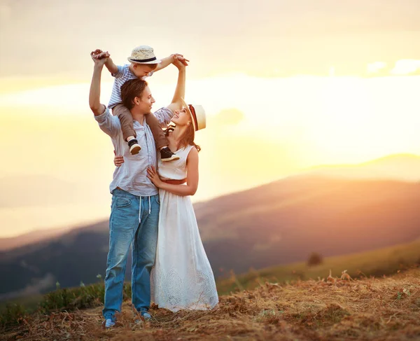 Happy family father of mother and child son  on nature at sunset — Stock Photo, Image