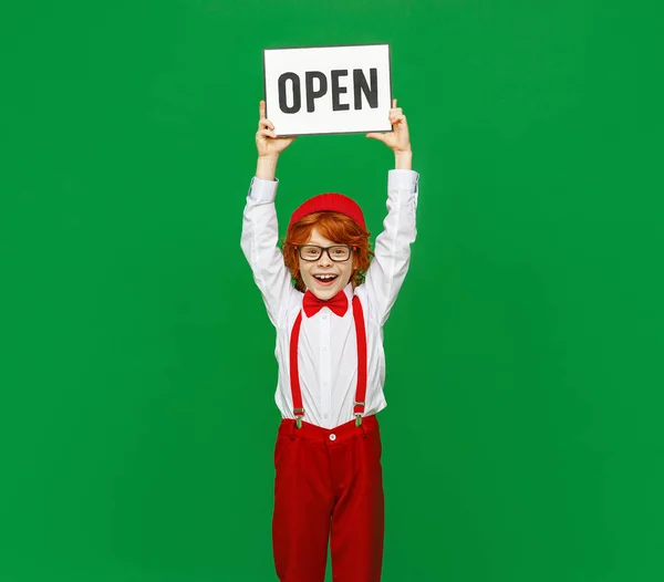 Positive Redhead Boy Trendy Clothes Glasses Smiling Camera Showing Signboard — Stock Photo, Image