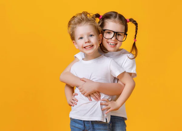 Delighted Smart Girl Embracing Smiling Little Brother Looking Camera Isolated — Stock Photo, Image