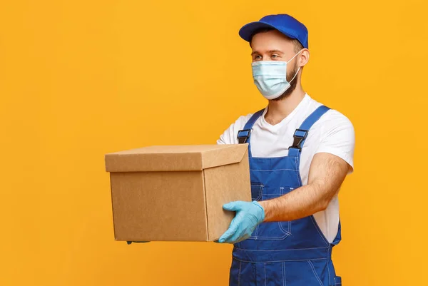 Male Courier Protective Mask Gloves Giving Carton Box Camera While — Stock Photo, Image