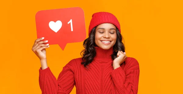 Happy Young Ethnic Female Closed Eyes Adjusting Knitted Hat Smiling — Stock Photo, Image