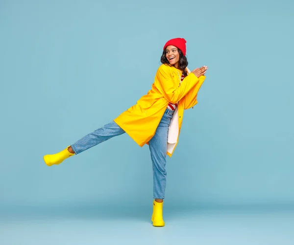 Mujer Étnica Alegre Cuerpo Completo Impermeable Botas Sonriendo Pateando Aire —  Fotos de Stock