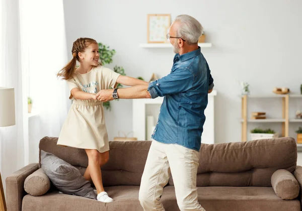 Happy Family Girl Smiling Dancing Aged Grandfather While Standing Sofa — Stock Photo, Image
