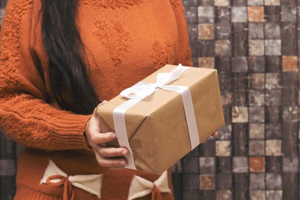 closeup woman holding present . Festive backdrop for holidays: Birthday, Valentines day, Christmas, New Year.