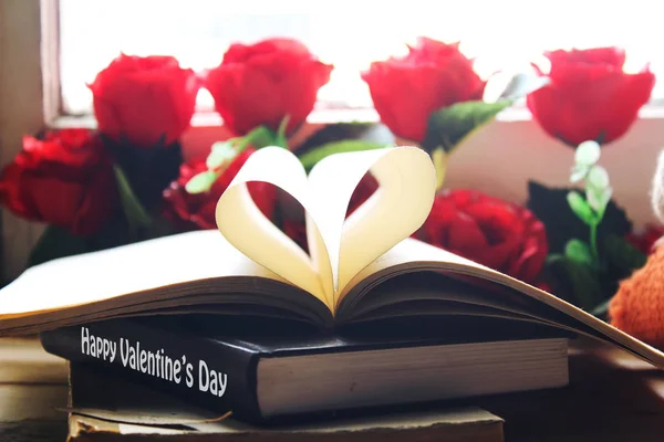 happy valentines day book and heart shape from paper with red roses