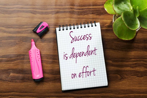 Success Is Dependent On Effort  text writing in notebook . Concept meaning Make effort to Succeed Stay Persistent