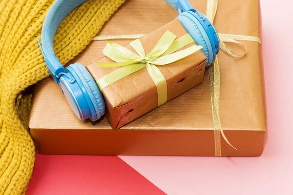 Christmas music gift concept. Headphones and gift boxes on colorful background