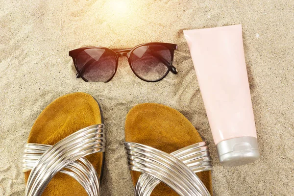pink tube cream, and sunglasses, slippers. summer beach concept