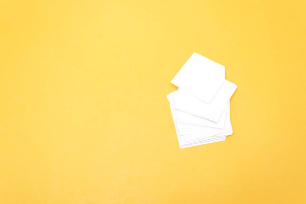 Mockup of business cards fan stack at white textured paper background.