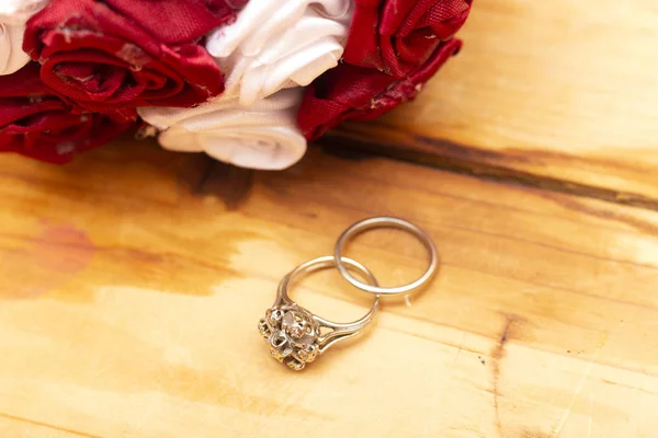 Engagement ring  with bright bouquet of flowers. The offer to get married. Gift for St. Valentine's Day. Marriage proposal for beloved woman