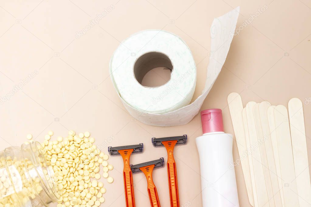 Personal hygiene : Toilet paper roll and yellow wax, wooden stick, shaver and intimate lotion