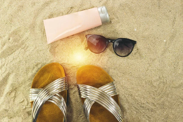 pink tube cream, and sunglasses, slippers. summer beach concept