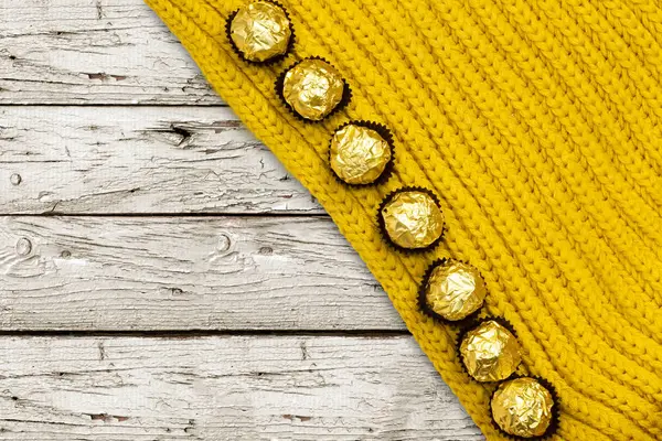 Goldene Premium Schokoladenbonbons Über Wollenen Winterschal — Stockfoto
