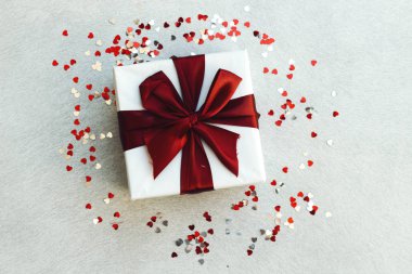 Hediye kutusu ve kalp konfetisiyle süslenmiş mutlu noeller. Xmas ve yılbaşı kartı. Düz yatış, üst görünüm