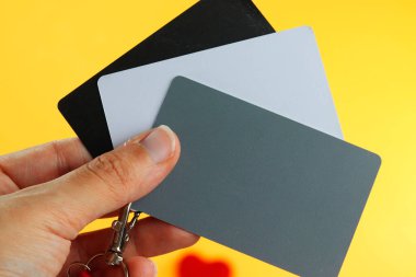 Kırmızı kayışlı gri kart, doğru beyaz dengeyi belirleyen bir fotoğrafçı aracı