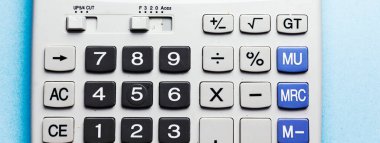 gray big calculator isolated on green background
