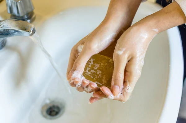 Woman washing hands with hypoallergenic soap at home — ストック写真