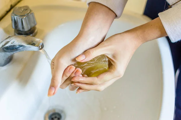 Woman washing hands with hypoallergenic soap at home — ストック写真