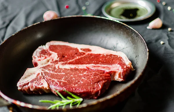 T ben biff av nötkött kött mot svart bakgrund — Stockfoto