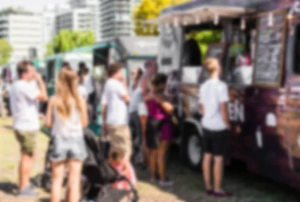 La gente ad un festival di mercato di cibo di strada in una giornata di sole. Sfocato di proposito . — Foto Stock