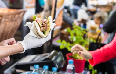Şef bir sokak gıda pazarında bir foodie bir tortilla teslim