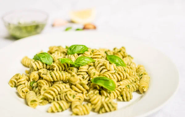 Pasta with basil and cheese pesto against white background — Stock Photo, Image