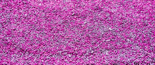 Arrière-plan de saupoudres violettes colorées. Texture et motif des aliments . — Photo