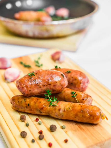 Grilled barbecue chorizo meat sausages on a wooden board.