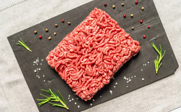 Colorful mince meat from angus wagyu beef against black background.